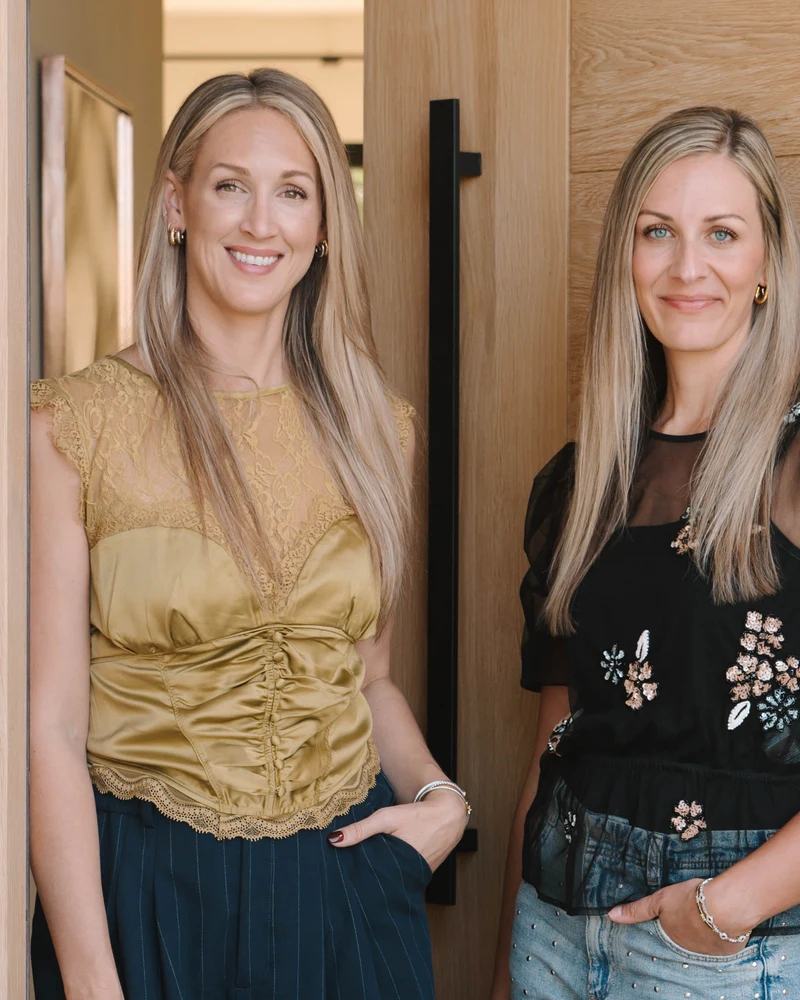 TwoPages founders together in the doorway of a warm modern home