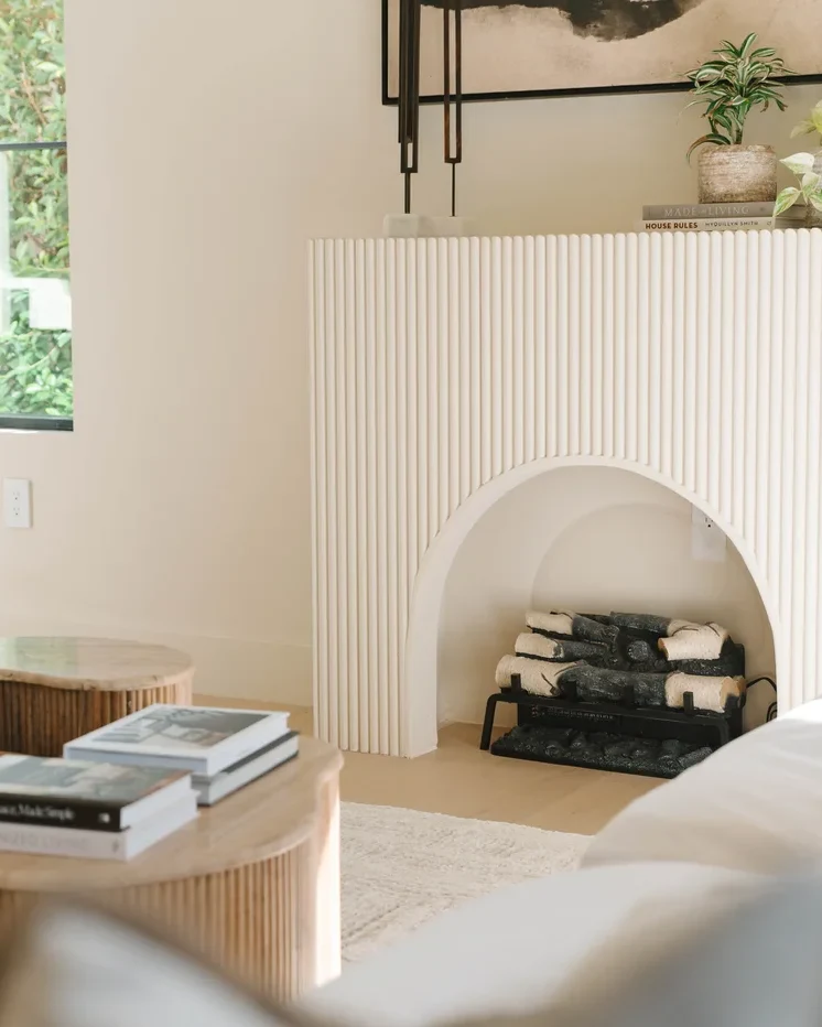 Warm, sunlit interior styled with layered neutral textiles